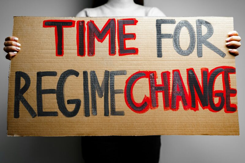 'Time for regime change' protest placard close up