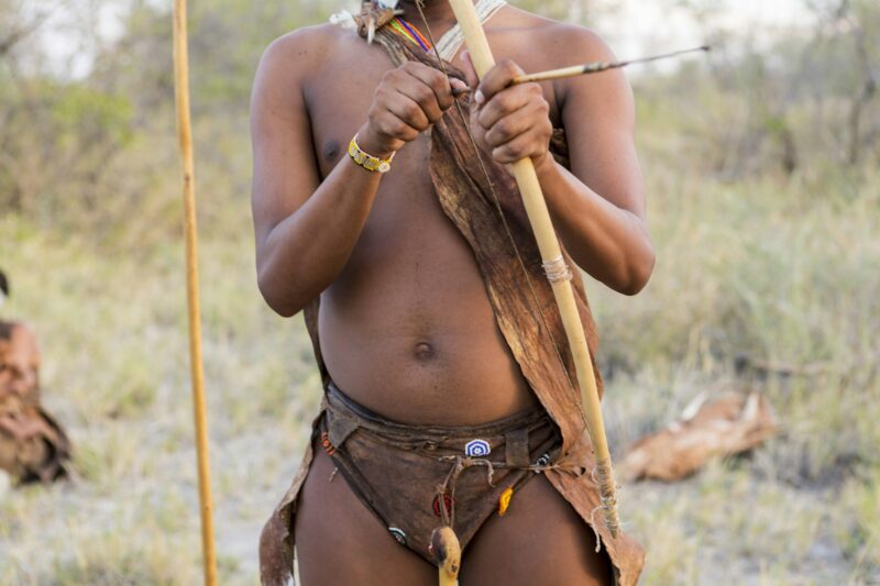 A San Bushman holding bow and arrow, Kalahari Desert