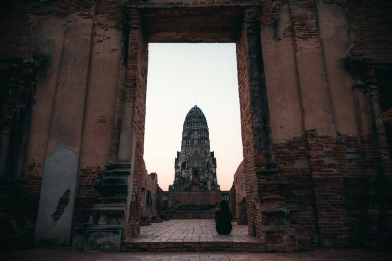 A woman sitting alone in ancient temple in Ayutthaya , Thailand