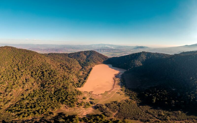 Aerial view of El Calaque dam and laguna El Calaque showing low water levels during dry season