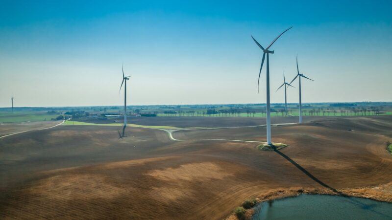 Aerial view of wind turbines in sunny day