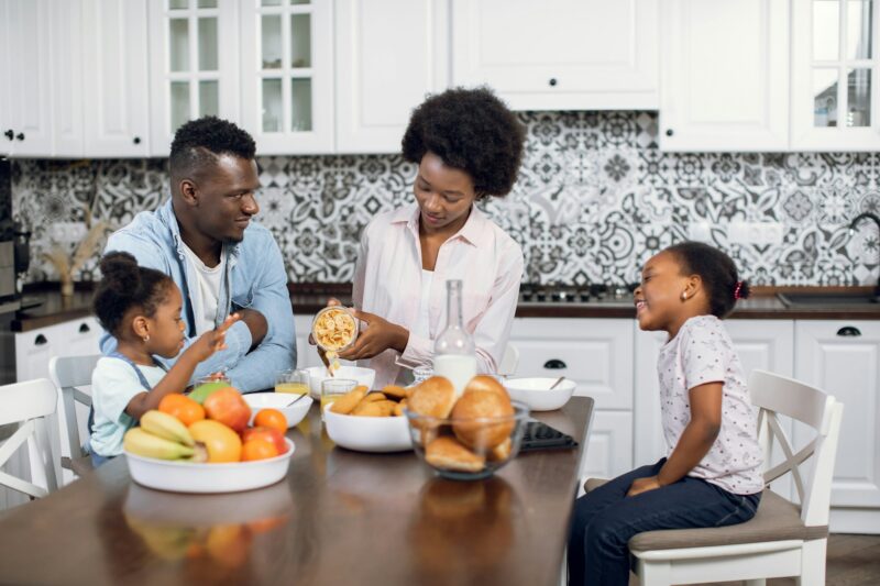 African american family eating cereals with milk at home