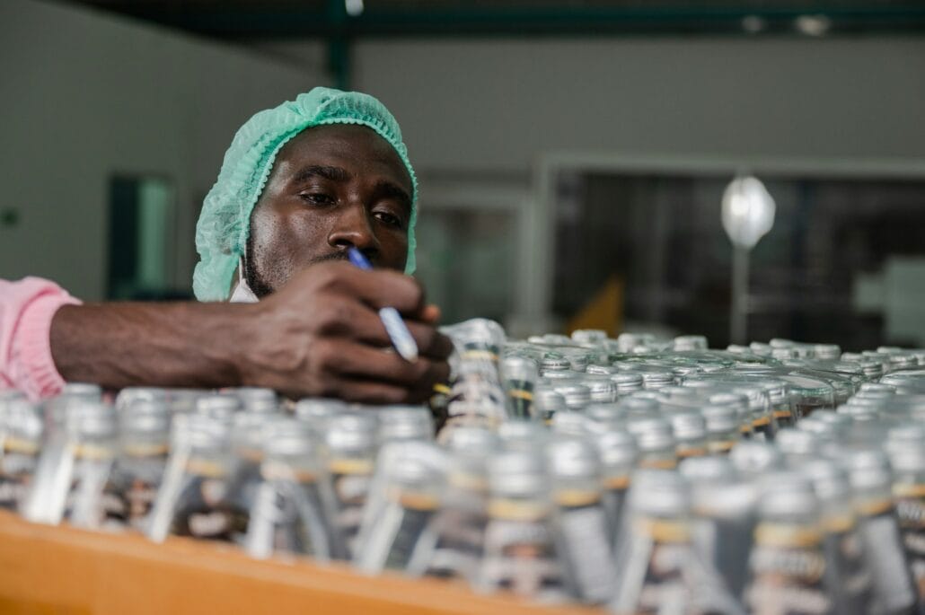 African American inspection worker engineer are work in drink water manufacturing factory