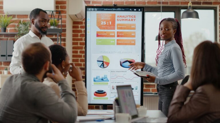 African american people receiving applause from colleagues at business meeting