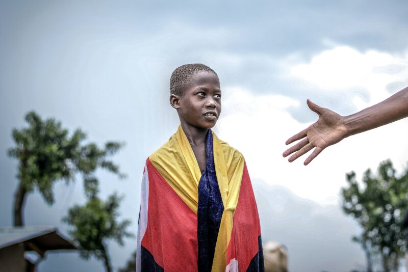 African Boy looking at a raised Hand