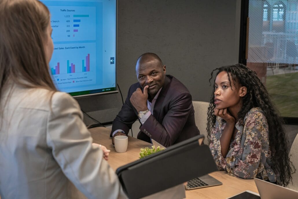african businessman and businesswoman look presentation of colleage in meeting room