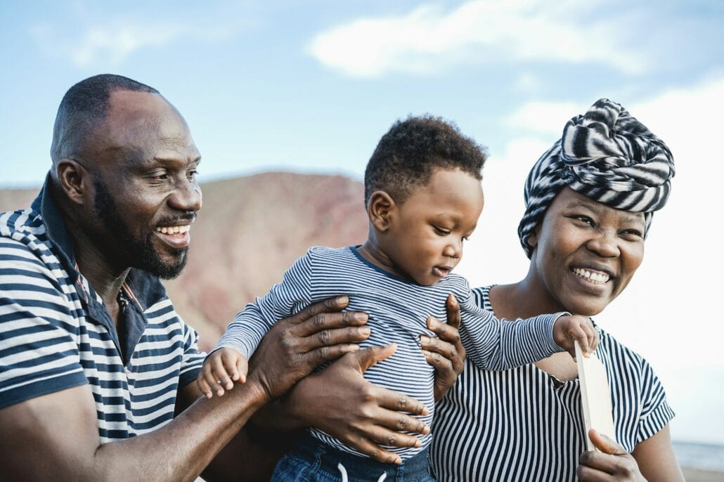 African family playing on the beach in summer vacation