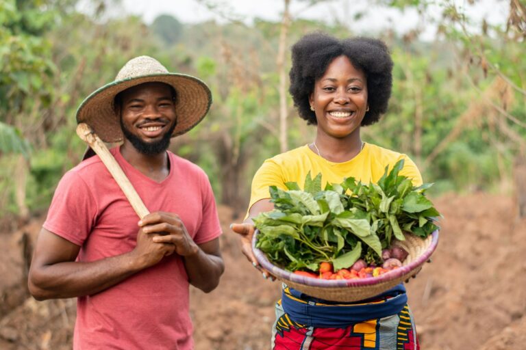 african farmers carrying vegetables and a hoe