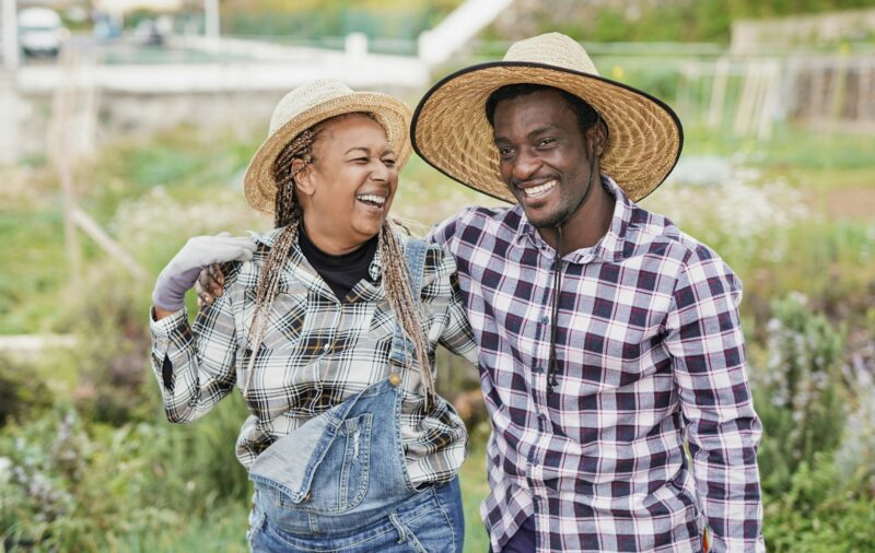 African farmers having fun together during harvest period - Farm lifestyle and black people