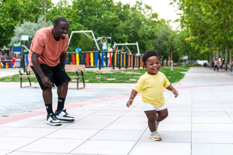 African Father and Son: Joyful Bonding in Urban Park