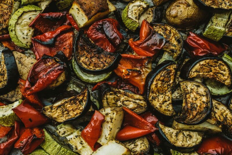 Baked vegetables: tomatoes, eggplants, peppers and zucchini. Background