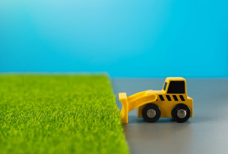 Bulldozer clears fertile land for construction.