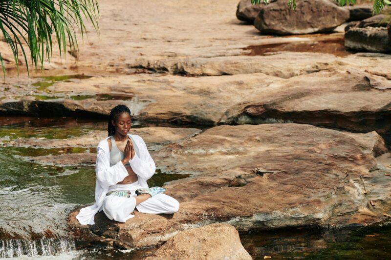 Calm beautiful woman meditating outdoors