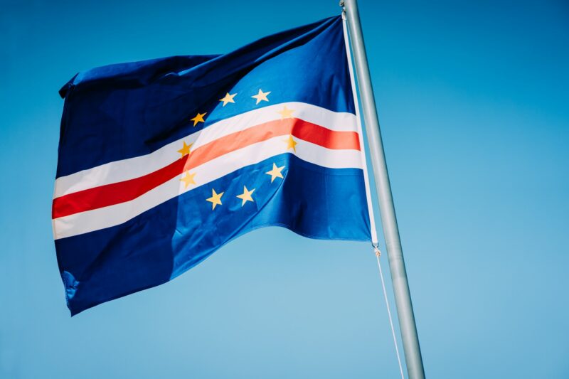 Cape Verde flag waving on the mast with blue sky background