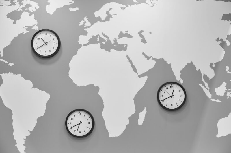 Clocks in a world map. Global time. Travel and geography