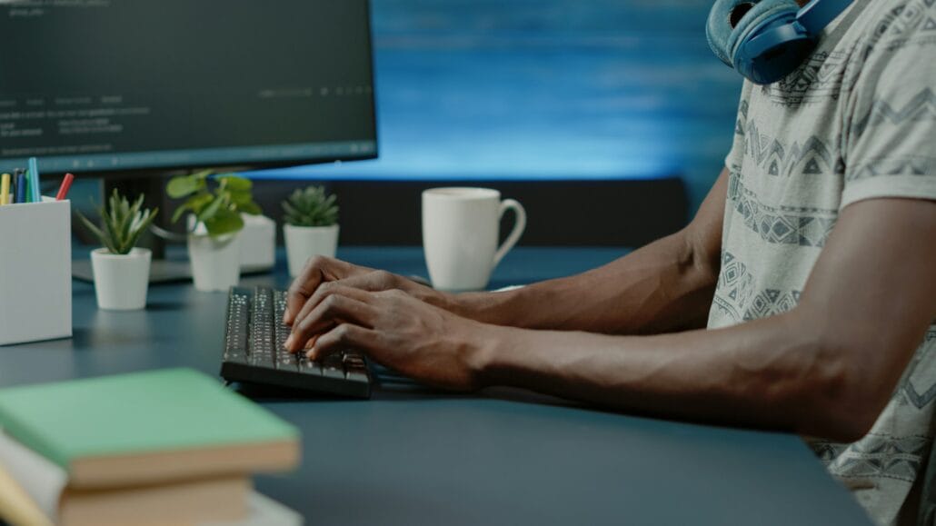 Close up of black hands coding server interface with binary codes