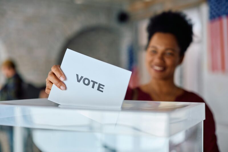 Close up of black woman voting during election day.