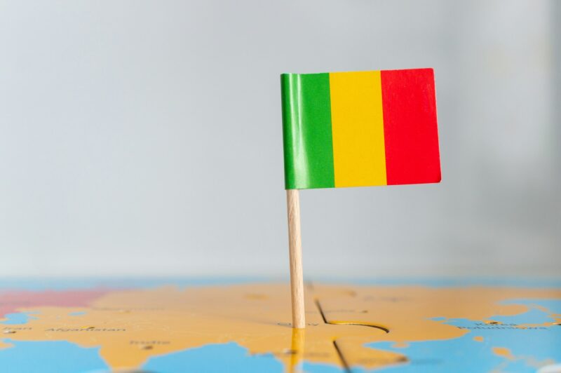 Closeup of a small Mali flag on a world map puzzle