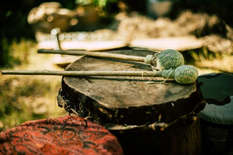Closeup of a traditional musical drum with sticks in the garden