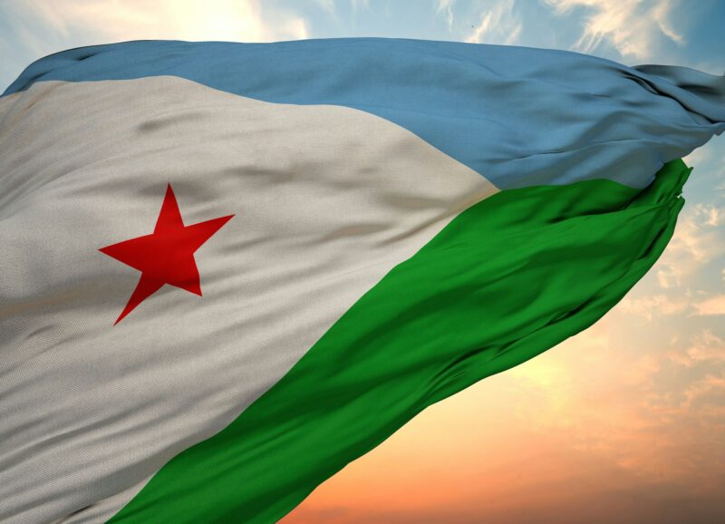 Closeup view of the flag of the Djibouti on a background of sunset