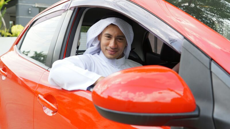 Couple Arab people travel in the red car