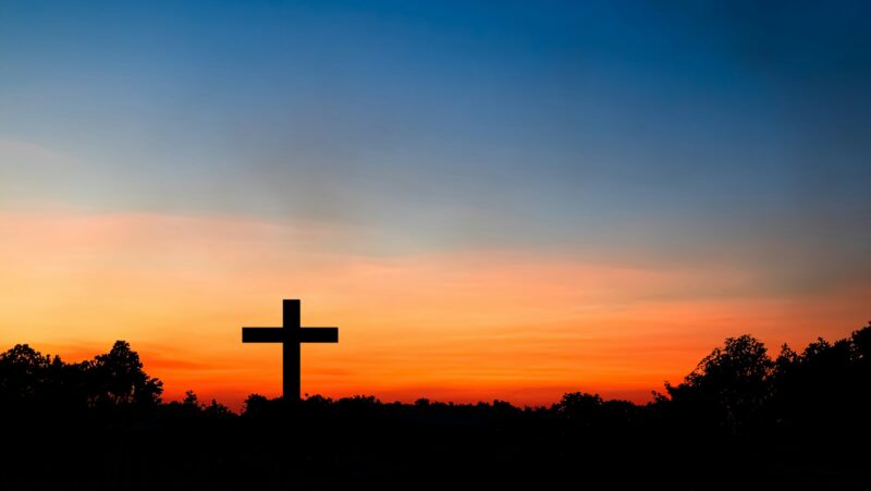 Cross Christian God Religion on Sunset Background
