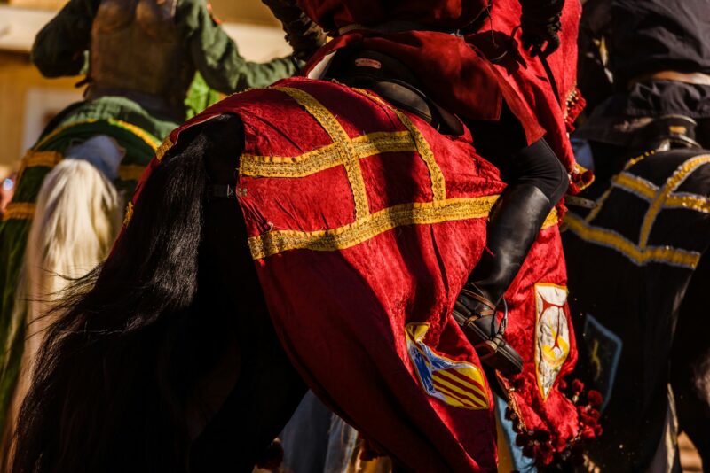 Detail of the armor of a knight mounted on horseback during a display at a medieval festival.