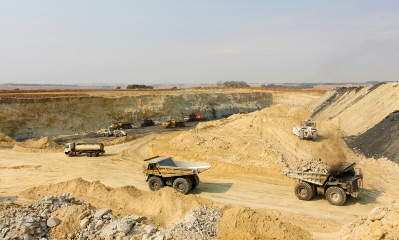 Dump trucks and excavators transporting manganese - manganese mining and processing