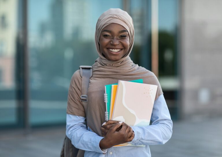 Education For Muslim Women. Smiling african islamic female college student posing outdoor