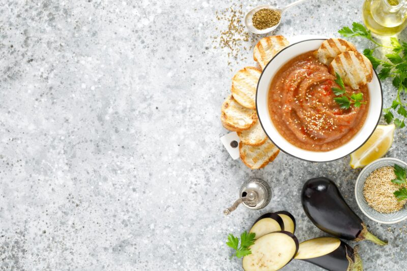 Eggplant hummus with ingredients for cooking. Vegan arabic aubergine appetizer. Baba Ghanoush