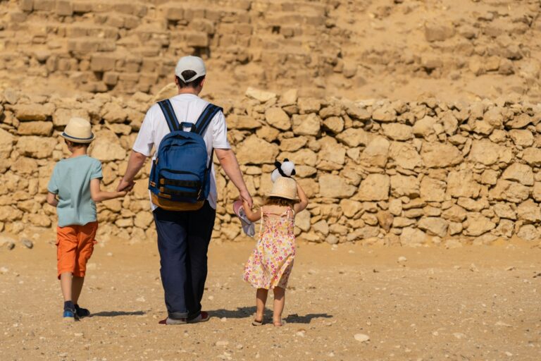 Father and children walk in front of the Chephren pyramid on the Giza plateau