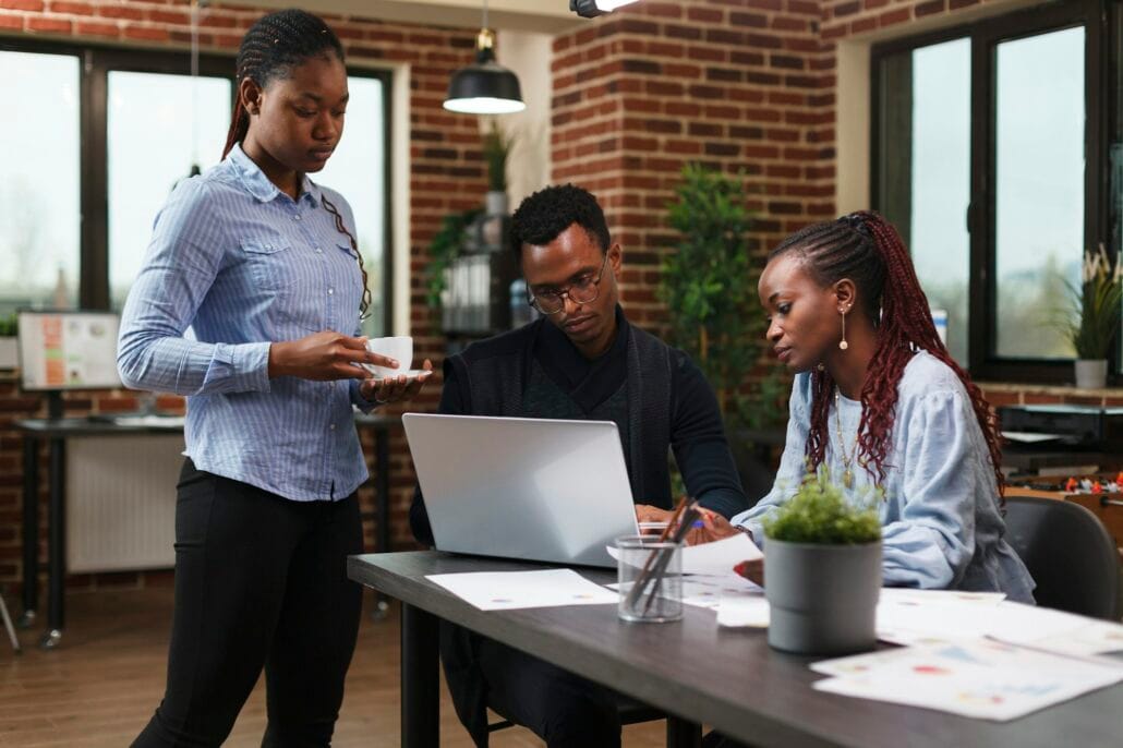 Financial company employees reviewing marketing strategy documentation and development plan