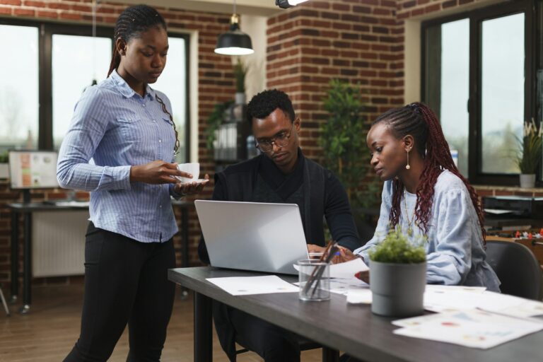 Financial company employees reviewing marketing strategy documentation and development plan