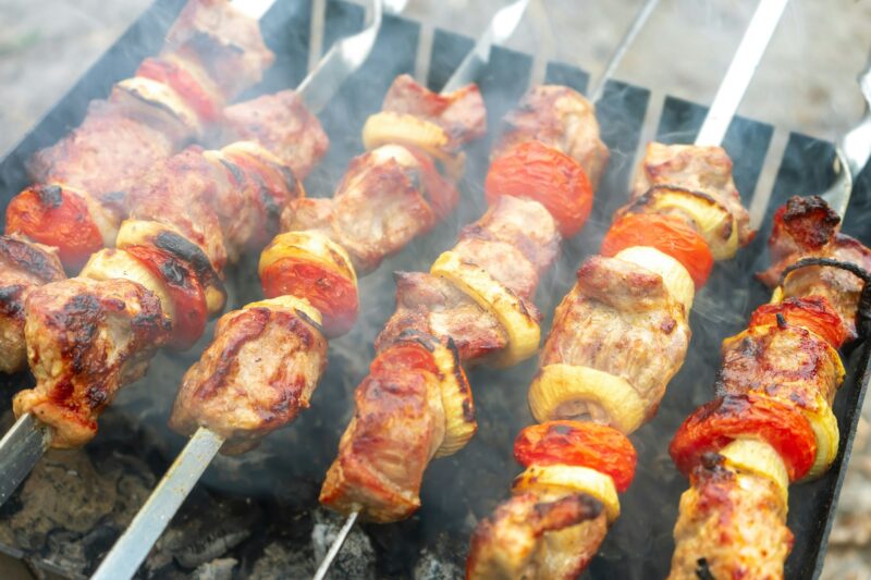 Grilled fried pork meat, pieces of meat on skewers.