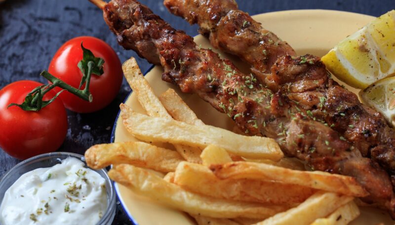 Grilled meat skewers in a dish