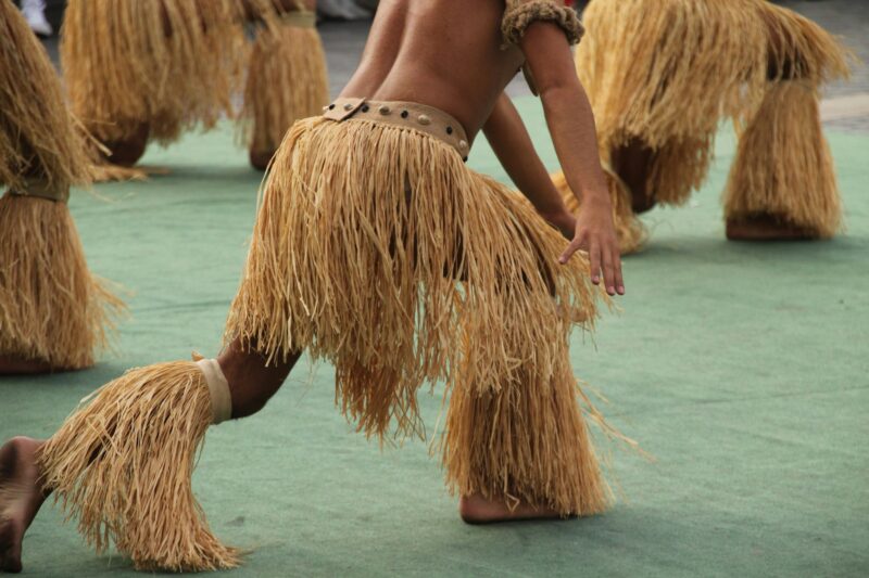 Group of eastern island folk dancers in an outdoor festival.