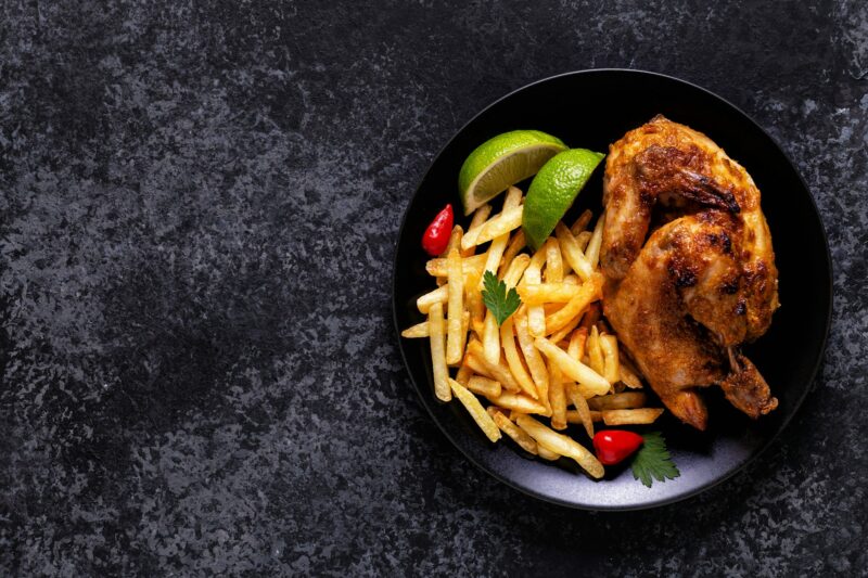 Half roasted chicken Piri Piri with french fries