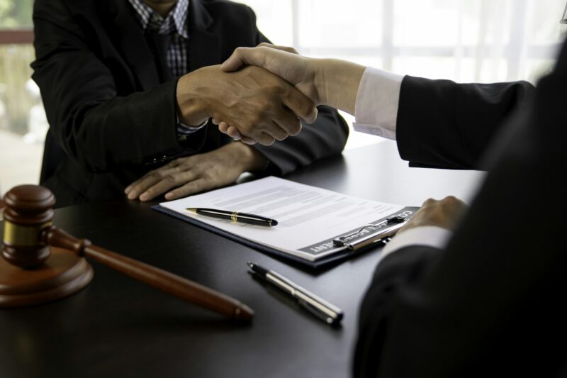 Handshake after consultation between a male lawyer and client, a lawyer is currently counseling the
