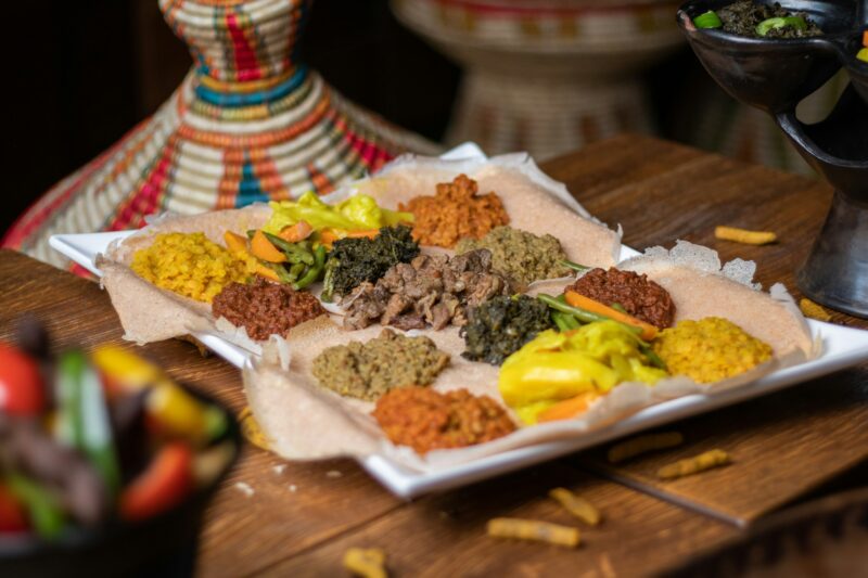 High angle shot of a plate of traditional Ethiopian food's ingredients on a wooden surface