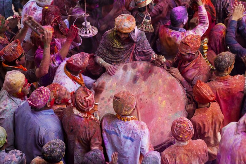 High angle view of crowds of people covered in colour at Holi, a Hindu spring festival.