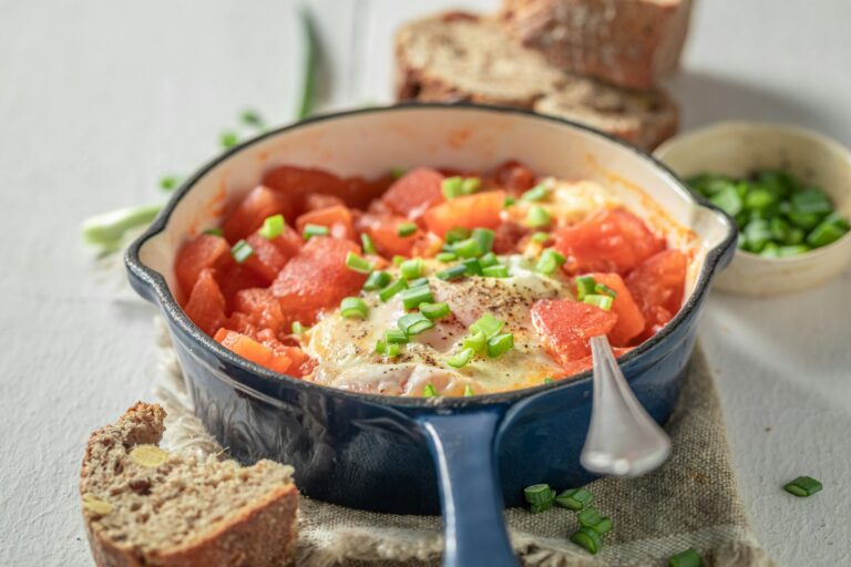 Homemade shakshuka served with bread for breakfast. Tunisian cuisine.