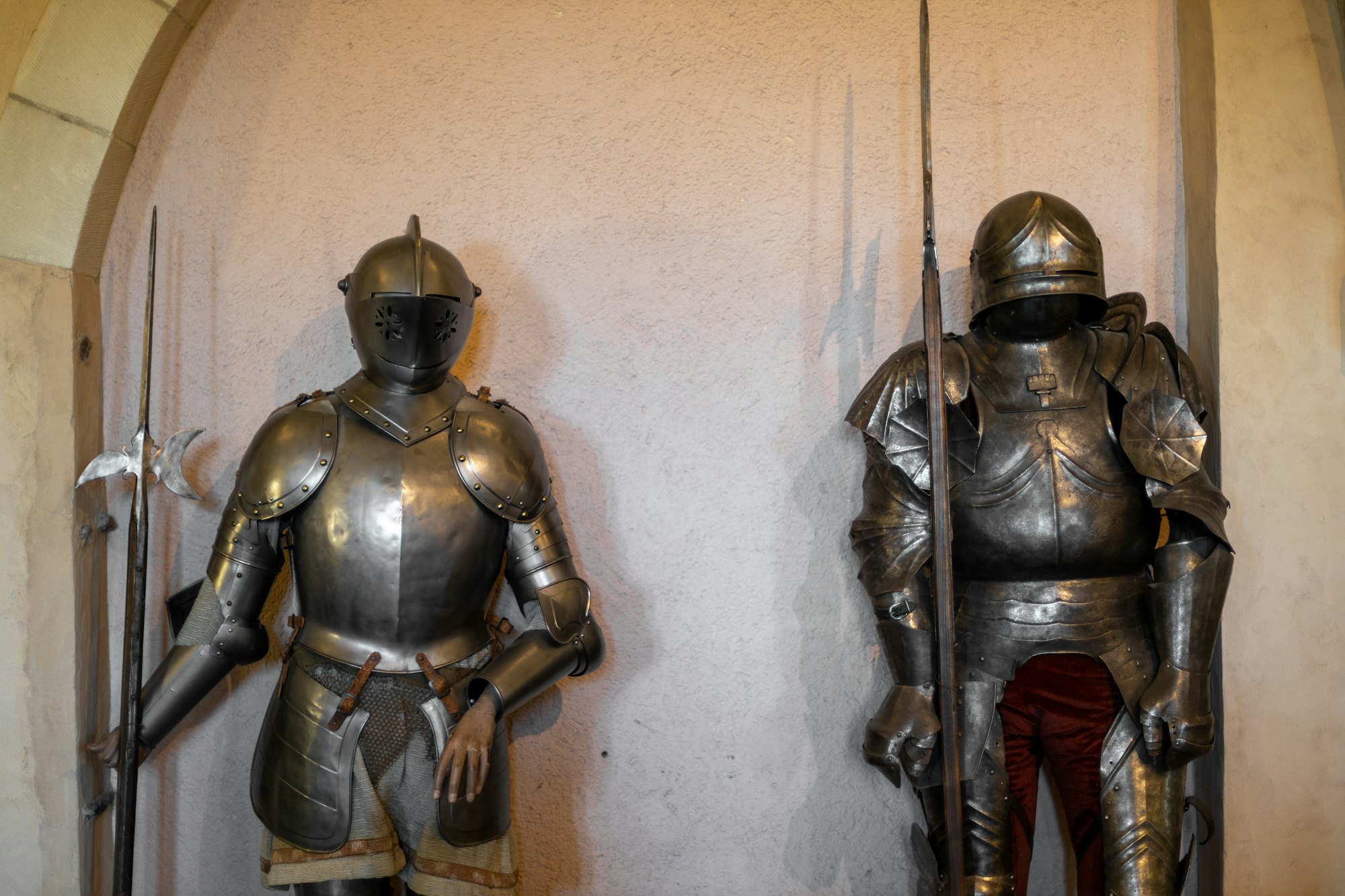 Knight's armor with a sword in a castle on the floor.