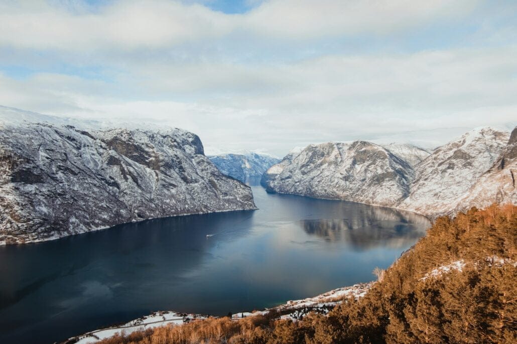Lake between hills in snow