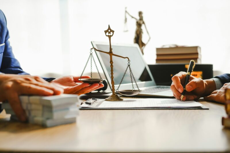 Legal expert navigating corruption cases, including bribery and graft. Businessman consults at desk.