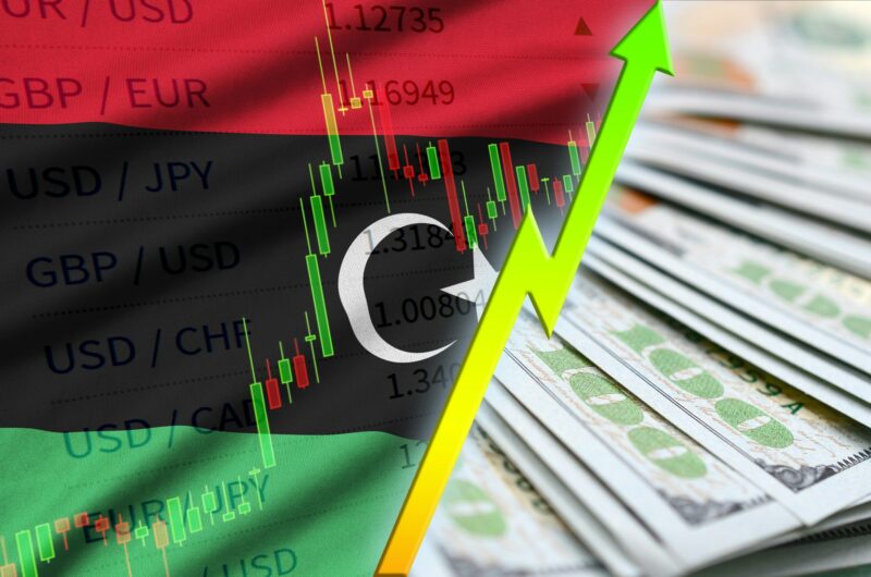 Libya flag and chart growing US dollar position with a fan of dollar bills