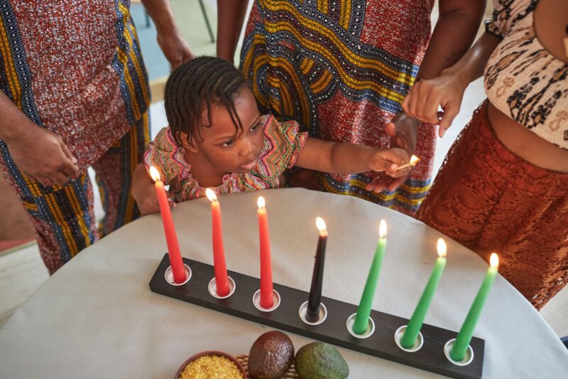 Little girl lighting candles for holiday