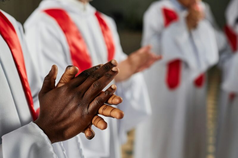 Man clapping while singing in church choir