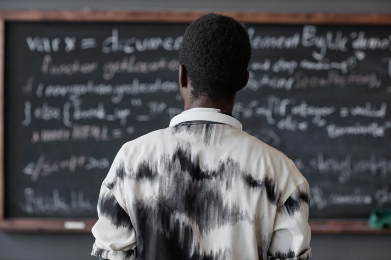 Man reading information on blackboard