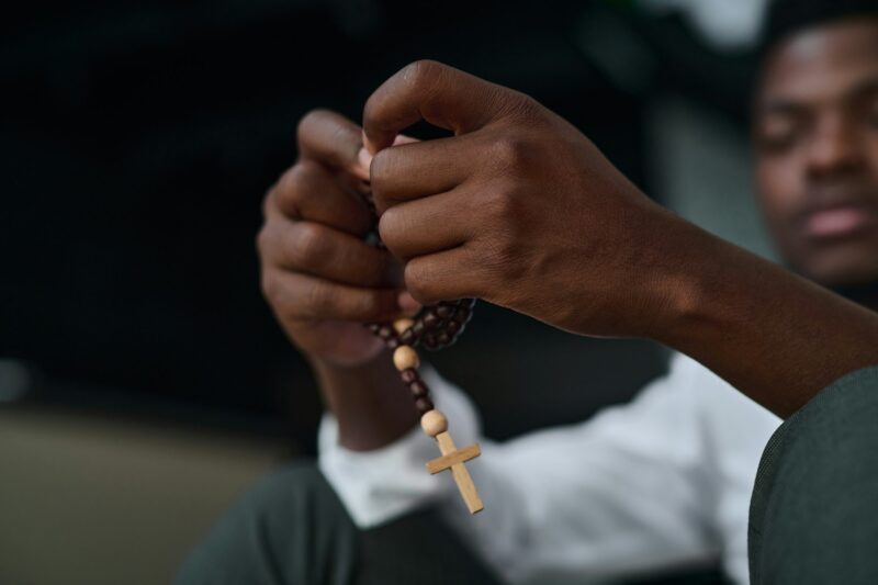 Man sitting with rosary beads