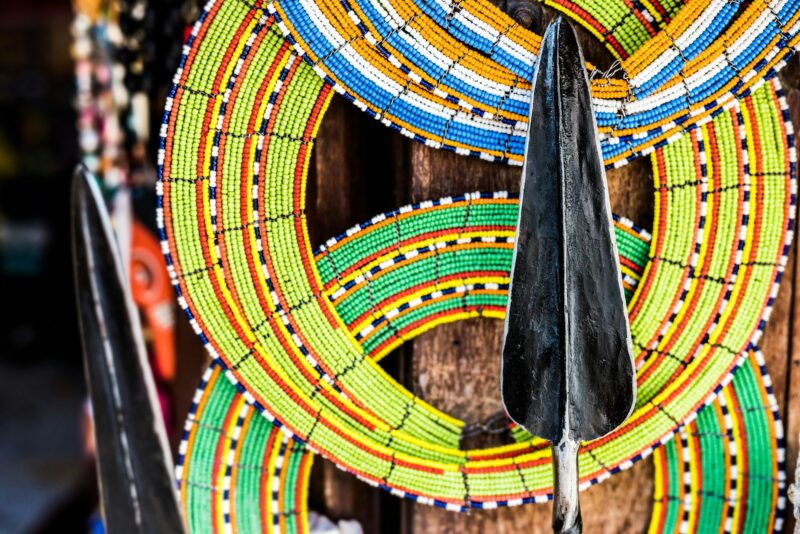 Masai colorful decorations and spear at market